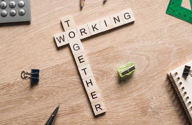 Working together words collected of game cubes on wooden surface